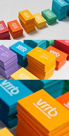 several different colored business cards stacked on top of each other