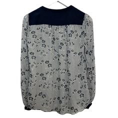 Diane Von Furstenberg Silk Blouse Navy Blue and white Floral Henley. Henley top with button details at the cuffs and balloon sleeves. Stitching details on the shoulders. Navy blue and white stripes with a floral print. Women's size 2. 100% silk. Item has a couple small pulls on the silk and a small pull on the stitches on the shoulder, as shown in photos. Measurements with the garment laying flat: Pit to pit: about 19.5 inches Length: about 24.5 inches Spring Striped Long Sleeve Blouse, Spring Long Sleeve Blouse With Striped Sleeves, Spring Blouse With Striped Long Sleeves, Chic Long Sleeve Blouse With Striped Sleeves, Long Sleeve Blouse With Striped Sleeves For Work, Spring Workwear Blouse With Striped Sleeves, Blue And White Floral, Stitching Details, Henley Top