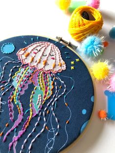 a close up of a embroidery project on a table