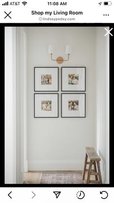 a white room with four pictures hanging on the wall and a stool in front of it