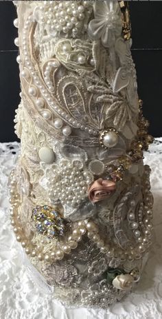 a close up of a vase with pearls and other things on the top of it