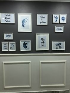 several framed pictures on the wall above a toilet in a room with tile flooring