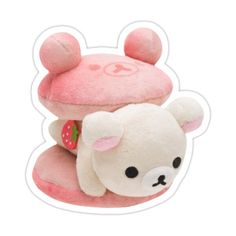 a small stuffed animal with a strawberry on it's head, sitting next to a pink mushroom