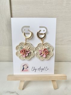 the earrings are on display in front of a card