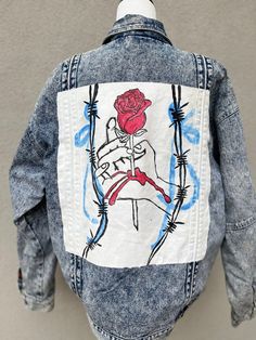 80's🔹One-of-a-kind hand painted denim jacket.♦️Glorious acid wash. Lined in plaid flannel. 🔹Emo/rock/punk-esque vibe. ♦️Pockets! Measures 27" in length / 46" in chest  Tag reads large - would look great on a S/M in an oversized look. Acid Wash Grunge Denim Jacket For Streetwear, Grunge Acid Wash Denim Jacket For Streetwear, Spring Edgy Denim Jacket For Alternative Fashion, Edgy Spring Denim Jacket For Alternative Fashion, Hand Painted Cotton Denim Jacket For Streetwear, Cotton Denim Jacket With Graphic Print In Grunge Style, Punk Style Denim Jacket For Spring, Spring Punk Denim Jacket For Alternative Fashion, Edgy Cotton Denim Jacket For Alternative Fashion