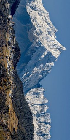 snow covered mountains and houses on the side