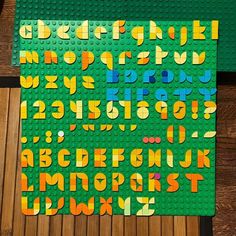 two pieces of lego type are laying on the floor next to each other with letters and numbers cut out