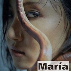 a close up of a woman with a snake on her face and the words marina written in spanish