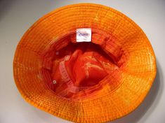 "This is another great sun hat. Cameo brand, kids size hat. Has about a 22\" finished size after shrinking. It did shrink about an inch during the dying process. Hats may stretch back to their original size. This hat is orange and red with non-cotton white stitching." Kids Bucket Hat, Stretch Back, Sun Hat, Sun Hats, Bucket Hat, Stitching, Sun, Orange, Hats