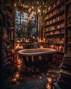 an old fashioned bathtub surrounded by candles and bookshelves in a dark room