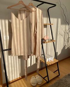 a clothes rack with a shirt and slippers on it