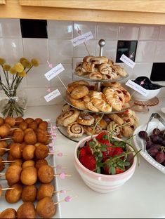 various pastries and desserts on display in a buffet style setting with strawberries