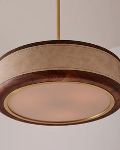 a wooden light fixture hanging from a ceiling