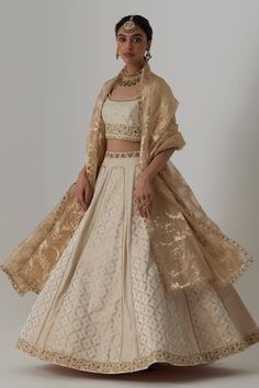 Off white panelled banarasi silk brocade, pure silk lehenga with bloom crest woven details and aari-zardozi embroidery highlights. Paired with a half sleeves floral bloom aari-zardozi embroidered blouse and floral woven banarasi brocade organza dupatta. - Aza Fashions Cream Cotton Silk Traditional Wear For Wedding, Traditional Drape Cotton Silk Fabric For Reception, Traditional Drape Embroidered Cotton Silk Fabric For Reception, Reception Traditional Drape Cotton Silk Embroidered Fabric, Transitional Cream Cotton Silk Sets, Wedding Cotton Silk Choli With Dupatta, Transitional Silk Traditional Wear In Off White, Transitional Off White Silk Traditional Wear, Transitional Off-white Silk Traditional Wear