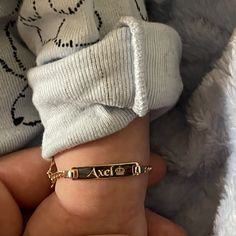 a baby's hand with a name bracelet on it