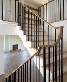 a wooden and metal staircase in an empty house