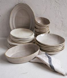 a stack of plates and bowls sitting next to each other