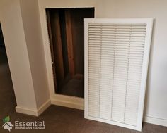 an empty room with white shutters on the wall and carpeted flooring in front of it