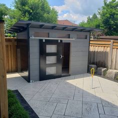 a small outdoor bathroom in the middle of a yard