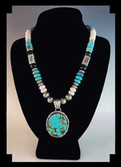 "For this White Fox Creation we started with a Pilot Mountain turquoise pendant. The pendant is set in a hand made scalloped sterling bezel accented with rolled and notched edge. Then we created a chain using chunky 10 mm turquoise, onyx and howlite rondelle beads, large Sterling Kokopelli stamped rectangular beads and large 10 mm Kokopelli stamped round beads.  Yes the pendant is easily removed so you can ware the chain alone.  Specifics: Metal: Sterling Silver  Stamped  Stones: Turquoise, Onyx Turquoise Round Pendant Jewelry Collectible, Southwestern Style Turquoise Round Pendant Jewelry, Southwestern Style Oval Jewelry With Large Pendant, Handmade Medallion Shaped Turquoise Jewelry, Artisan Turquoise Medallion Jewelry, Dragonfly Images, Organic Necklace, Pilot Mountain, Turquoise Gold Ring