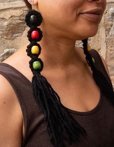 "*Ready for Shipment*  \"Colors of Africa\" Earrings This beautiful pair of earrings were designed and handmade my me with the greatest care and expertise. I absolutely LOVE these earrings and I know you will too! The colors are amazing and so vibrant! The colors used for creating these beautiful earrings are Black, Red, Yellow and Green.  The earrings are for pierced ears and measure 10\", including the fringe which measures 3\".  There is a clear clamp on the back of each clasp to keep your ea Black Earrings With Large Beads For Festival, Beach Jewelry With Black Dangling Beads, Black Dangling Beads Jewelry For Beach, Bohemian Black Earrings With Large Beads, Black Beach Jewelry With Dangling Beads, Felt Earrings, African Jewelry Earrings, Wooden Bead Earrings, Afrocentric Earrings