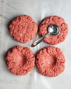 three hamburger patties with a spoon on top