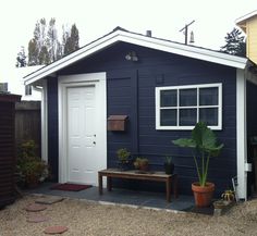 a small blue house with a white door