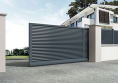 an image of a modern house that is painted white and has black slats on it