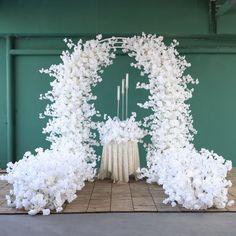 a table with white flowers and candles on it