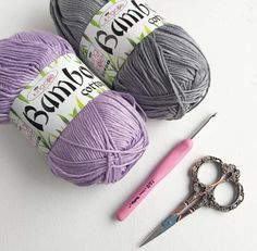 two balls of yarn and a pair of crochet scissors