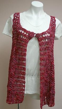 a crocheted vest on a mannequin with a white t - shirt