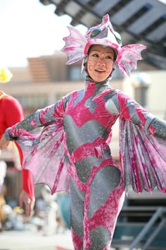 a woman in a pink and grey costume