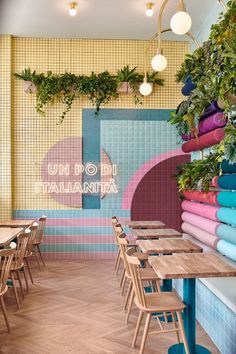 the interior of an italian restaurant with colorful tiles on the walls and wooden tables in front of them