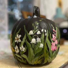 a painted pumpkin sitting on top of a counter