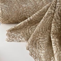 an image of gold lace fabric on white background