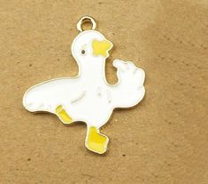 **Get this Charm for FREE with the purchase of any charm bracelet Good for charm bracelets, handbag charms, key rings, zipper pulls, and pendants Cute Enameled Dancing Goose Charm Flat back charm. Measures 1 X 3/4 inch. Zinc alloy, lead-free. Comes with a jump ring All items in stock and ships from Tennessee. Nickel-free White Enamel Charms, White Enamel Nickel-free Charms, Personalized White Metal Charms, Nickel Free White Charms For Gifts, White Enamel Charms For Gifts, White Enamel Charms For Jewelry Making, White Metal Charms For Gifts, White Novelty Jewelry With Charms, White Novelty Enamel Jewelry