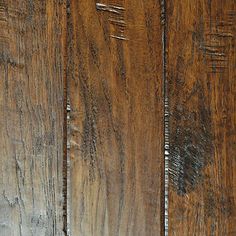 an old wooden door with peeling paint on the side and wood grains all over it