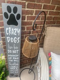 a sign with a dog's paw on it next to a lamp and pillows