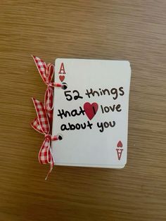 a card that says, 65 things that love about you on it with a red and white checkered ribbon