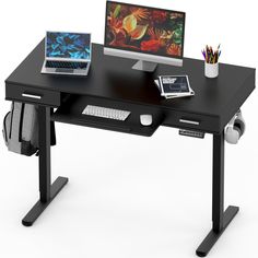 a computer desk with a laptop, mouse and other office supplies on top of it