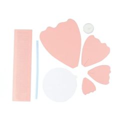 the tools needed to make a paper heart craft are laid out on a white surface