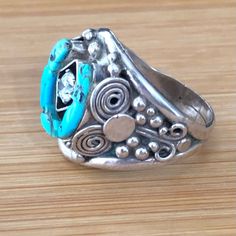 This Signed Native American Southwest Handmade Man's Ring (I Believe) Is Navajo; However, I Am Not Familiar With The Signature Of Jcy This Artisan Features In The Center Of The Ring A Cubic Zirconia & Is Encased By A Turquoise Horseshoe All Mounted In Fine Silver Crown Measures 1" By 1" Ring Is A Size 13 & 1/2 The Total Weight Is 14.6 Grams Native American Collectible Priced To Sell For $112 From The Genuine Stoner Closet Southwestern Multi-stone Turquoise Ring, Nickel-free Round Turquoise Southwestern Ring, Southwestern Style Nickel-free Sterling Silver Rings, Hand-strung Blue Southwestern Jewelry, Adjustable Southwestern Turquoise Ring Nickel-free, Silver Crown, American Southwest, Size 13, Fine Silver