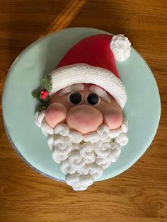 there is a cake that looks like santa claus on the plate with eyes and nose