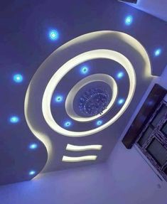 the ceiling is decorated with blue lights and circular designs on it, along with white walls