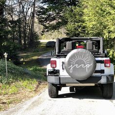 a jeep parked on the side of a road with a tire cover that says hope