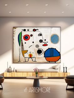 an abstract painting hangs on the wall above a coffee table