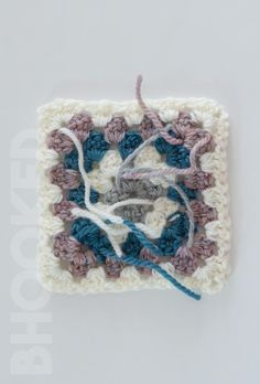 a crocheted square with yarn on it