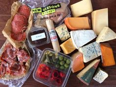 several different types of cheese and meats on a table