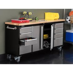 a workbench with drawers and tools on it