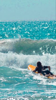 two people on surfboards riding waves in the ocean